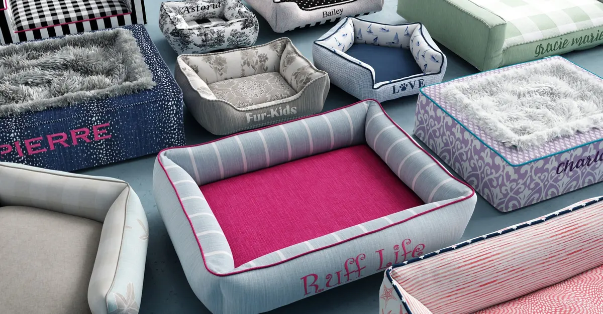 A room full of J'adore custom bolster and cushion beds, each embroidered with a pet's name