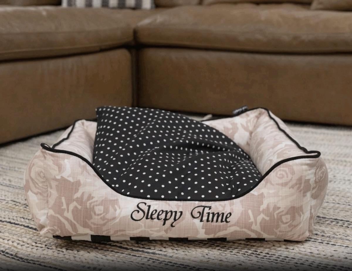 A bolster bed embroidered with the phrase Sleepy Time
