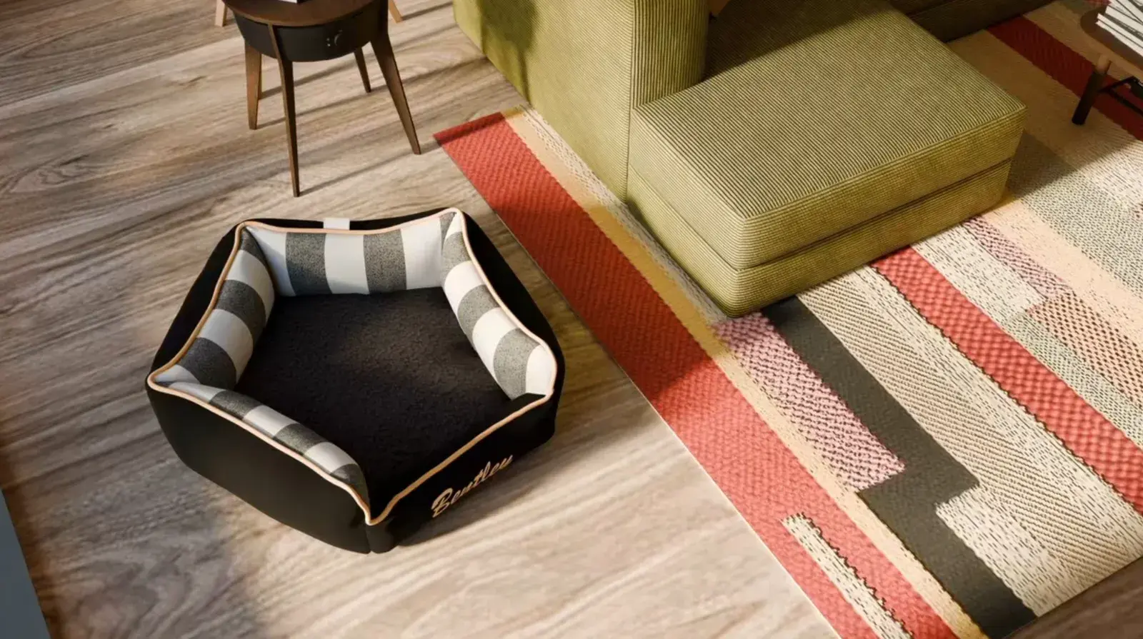 A Penthouse Bed in black with a striped bolster, embroidered Bentley, on a patterned rug