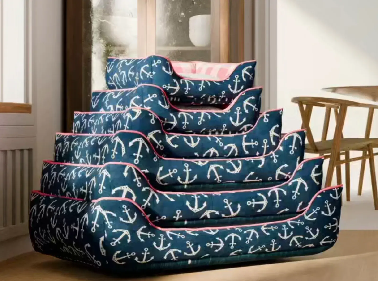 A stack of Cuddle Beds in navy anchor print, every size