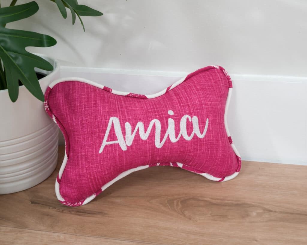 hot pink and white bone pillow for dog
