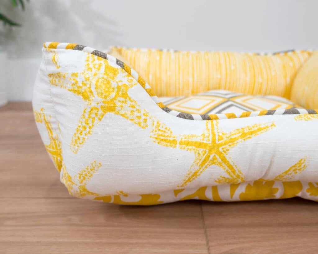 x-small nautical dog bed with yellow starfish close up