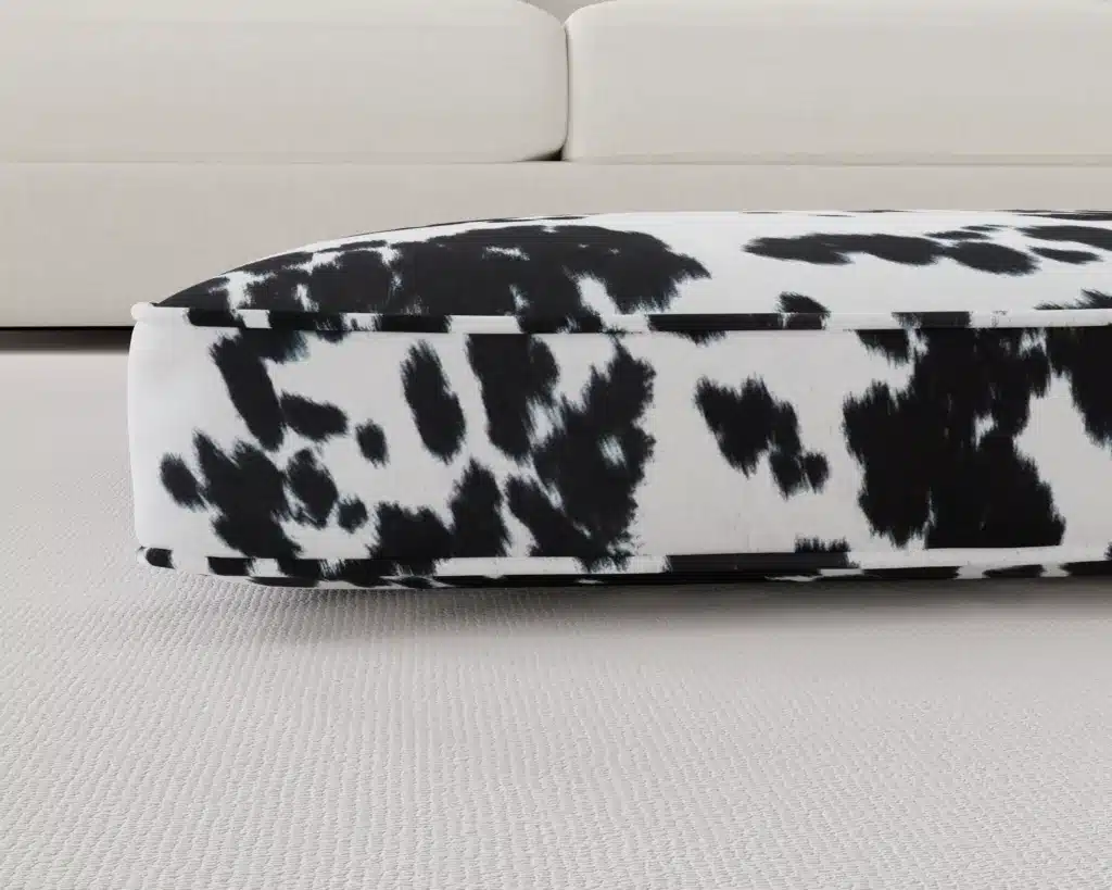 black and white faux cowhide dog bed cushion up close